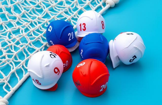 Selection of water polo team caps and a goal net.